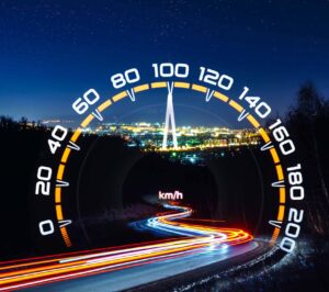 Double exposure of the starry sky above city lights, light tracks and car speedometer. Night astrophotography