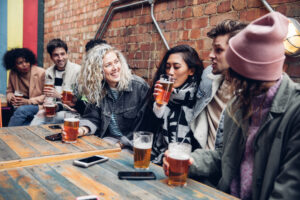 Group of friends drinking beers in a pub.